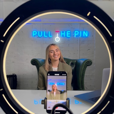 Blue Custom Neon® company name logo sign on white wall @pullthepinagency