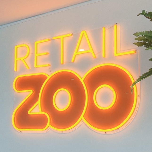 Custom Neon® orange UV Print logo sign @retailzoo