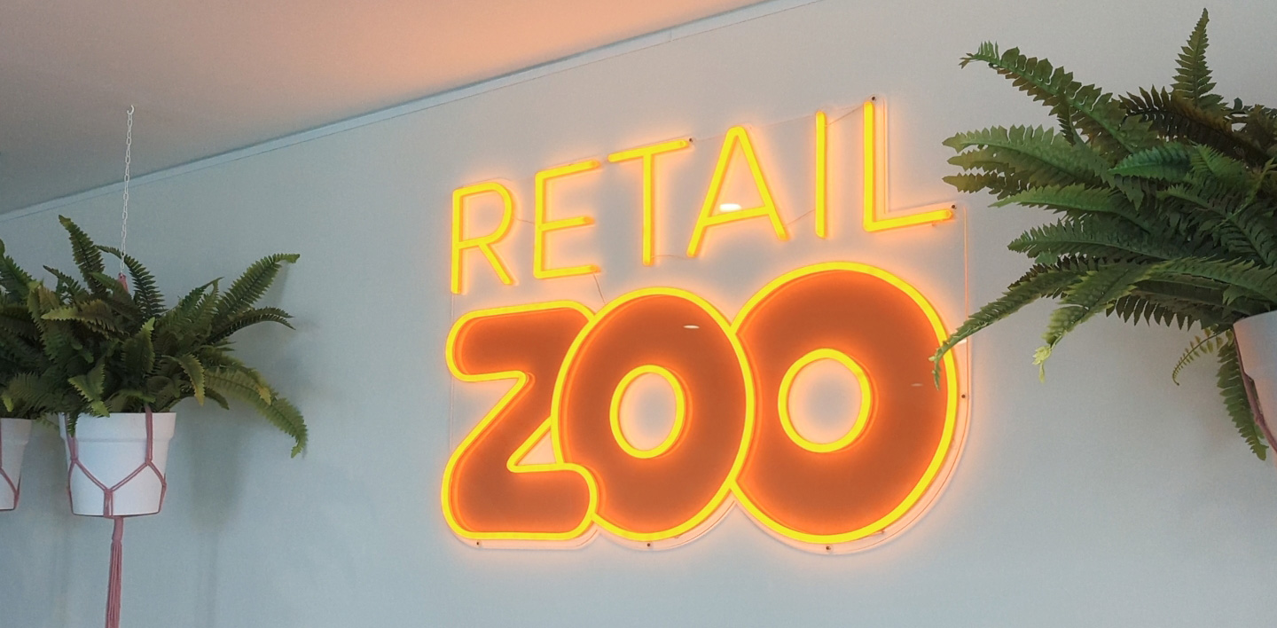 Custom Neon® orange UV Print logo sign @retailzoo