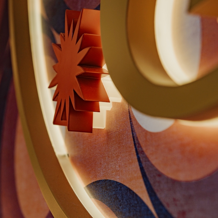 Close up of a gold and red coloured stainless steel reverse lit logo made by Custom Neon® in the Golden Days tanning salon