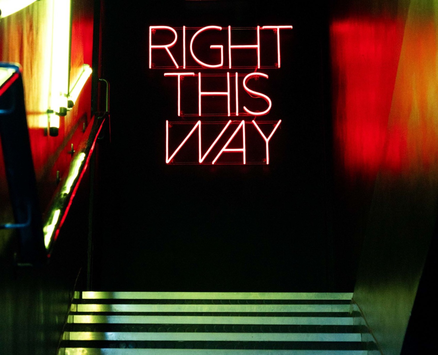 Custom Neon® directional sign with Naked Neon™ backing