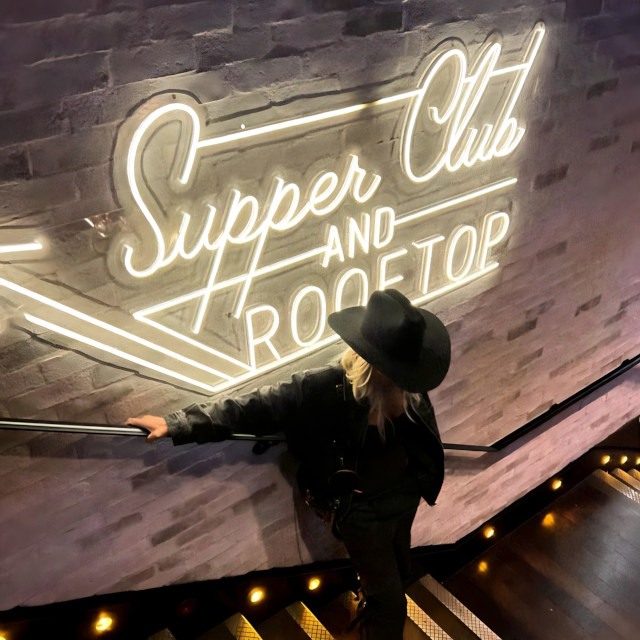 Custom Neon® warm white waterproof directional arrow sign pointing to the Rooftop Supper Club @thetwelvethirtyclub