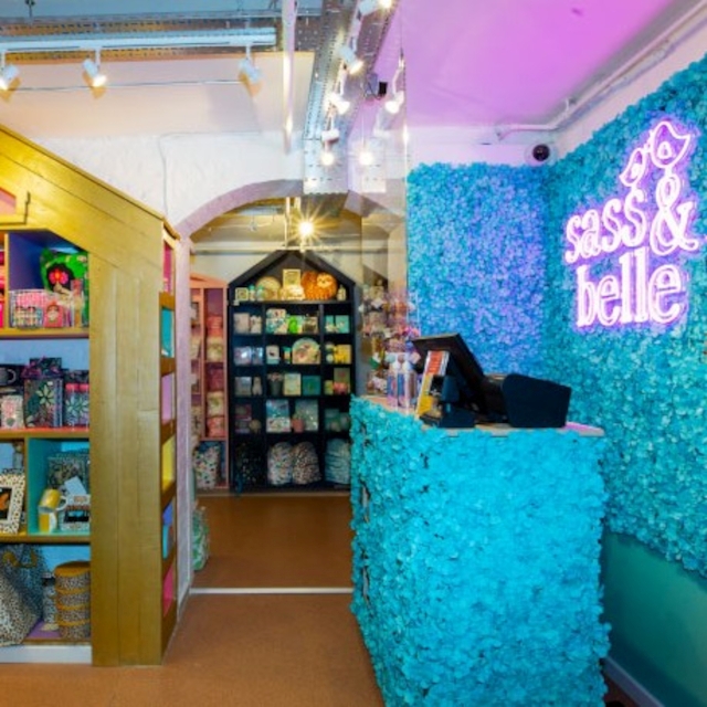Pink Custom Neon® logo sign on feature wall @sassandbelle