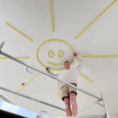 Custom Neon® smiley sun being ceiling mounted by @loopelec