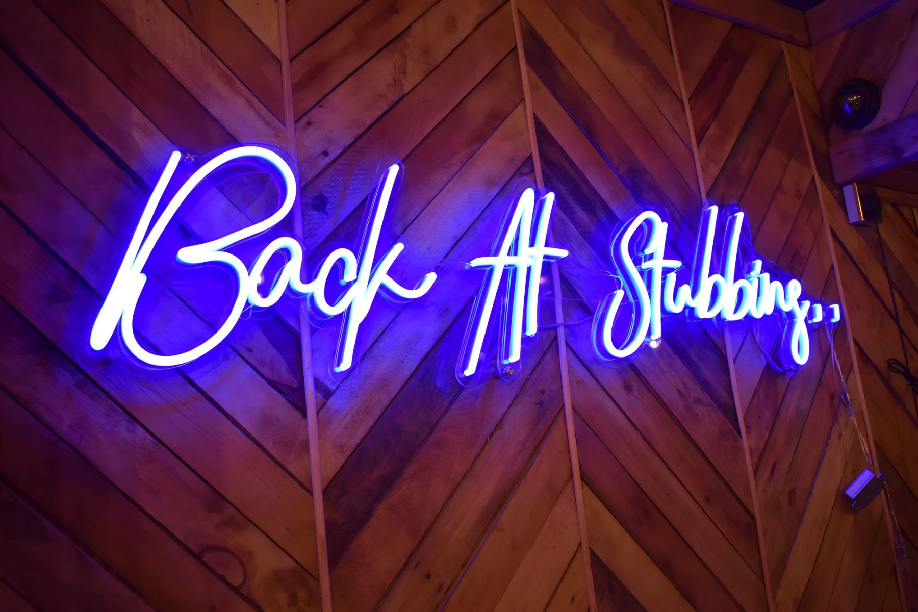 Electric blue Custom Neon® slogan sign @stubbinstandoori