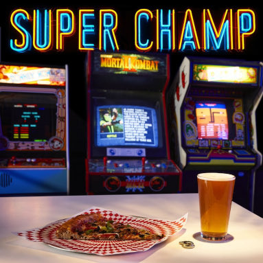 Custom Neon® retro arcade sign above arcade machines and a pizza slice @superchampsuperfun