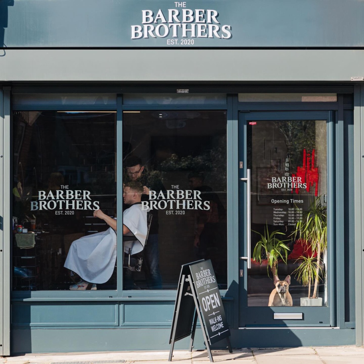The Barber Brothers shopfront with a red Custom Neon® business name sign seen through the window @thebarberbrothers_uk Northampton