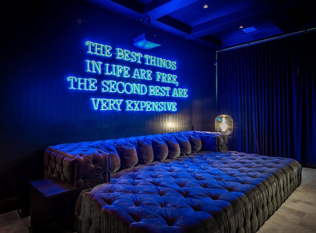 Large blue Custom Neon® home theatre sign @morroneinteriors