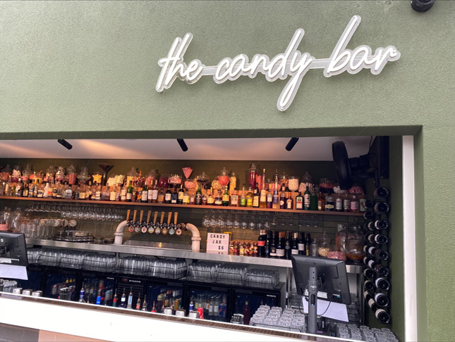 Custom Neon® white outdoor sign The Candy Bar on the roof @thebeaufortperth