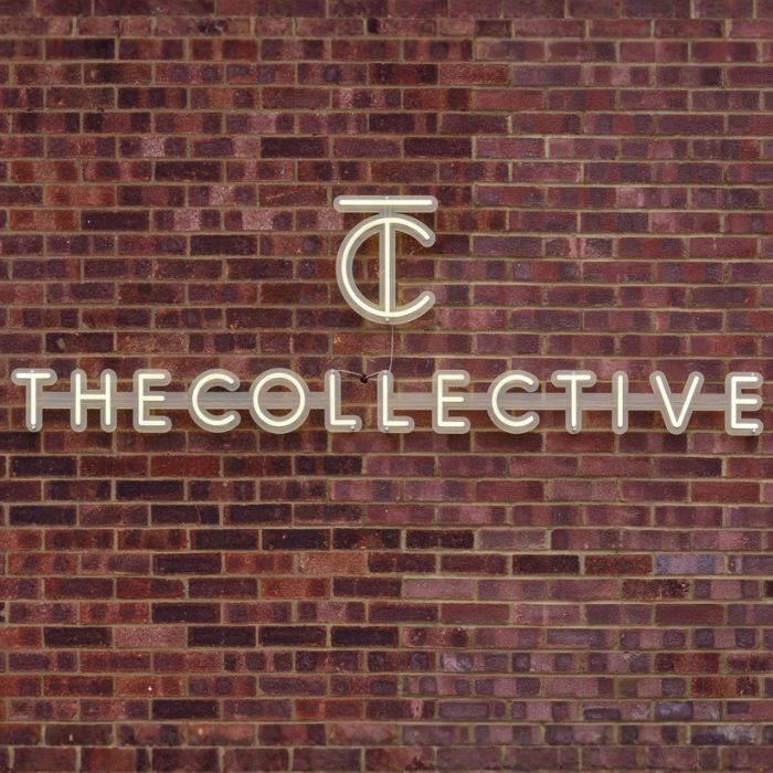 Custom Neon® logo sign on a brick wall @thecollectiveagency