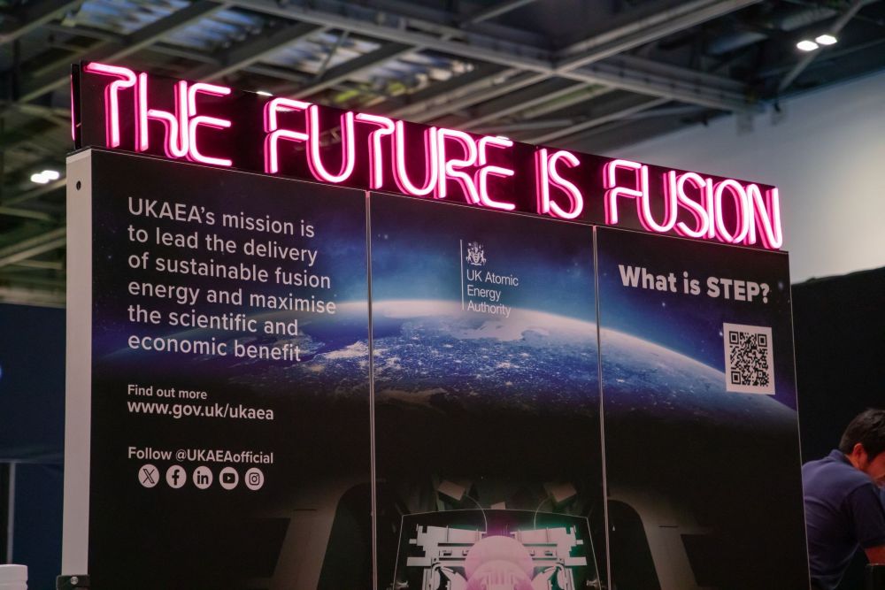The Future is Fusion pink Custom Neon® double sided sign at the top of the UKAEA display during the @bigbangukstem Young Scientists and Engineers Fair