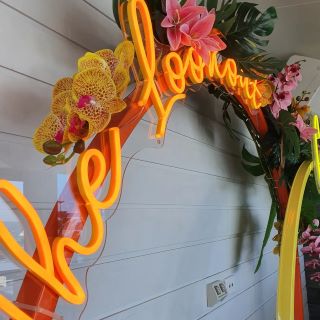 Orange Custom Neon® sign hung on arch @thelookout