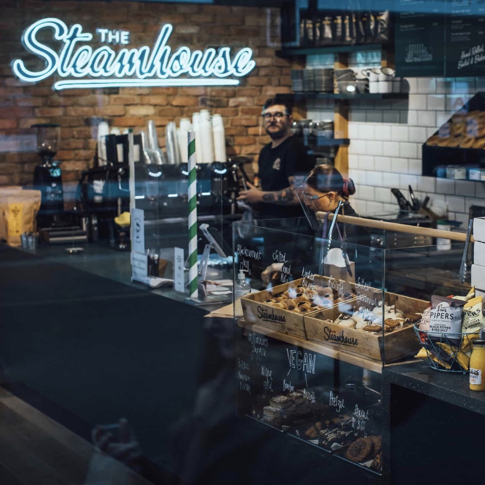 The Steamhouse large blue Custom Neon® LED flex and UV print sign on a brick wall @thesteamhousebakery