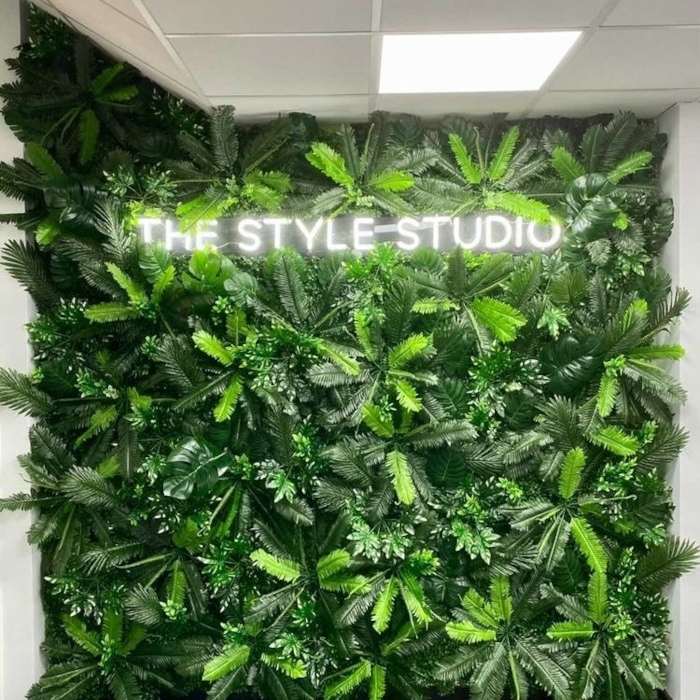 White hair salon name sign on a grass wall by Custom Neon®