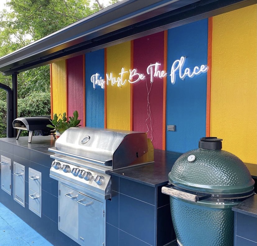 This Must be the Place white Custom Neon® sign above an outdoor BBQ/kitchen @shaunaglenn