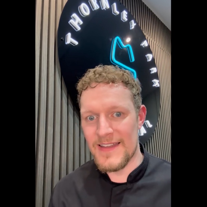 Custom Neon® white and blue round LED neon Thornley Park Dental sign on a black acrylic backing