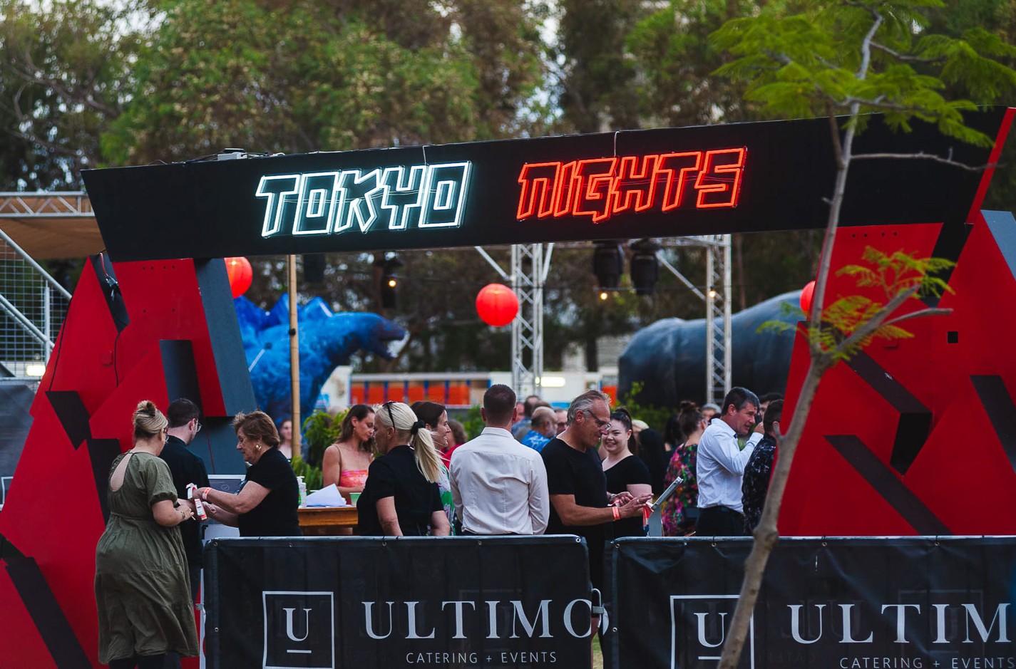 Red and white outdoor Custom Neon® directional signage @ultimocatering