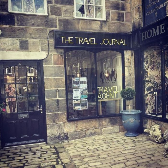 Travel Agent Journal shop in Harrogate with a Travel Agent yellow Custom Neon® sign in the window