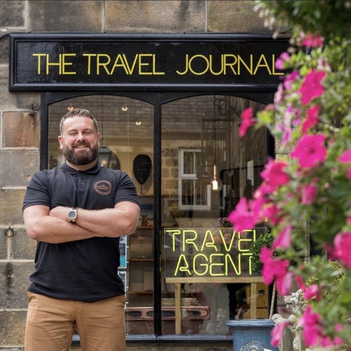 Travel Agent Journal shop in Harrogate with a Travel Agent yellow Custom Neon® sign in the window