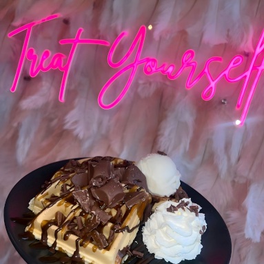 Treat Yourself pink Custom Neon® sign above a plate of waffles and ice cream @cakecorner.southport