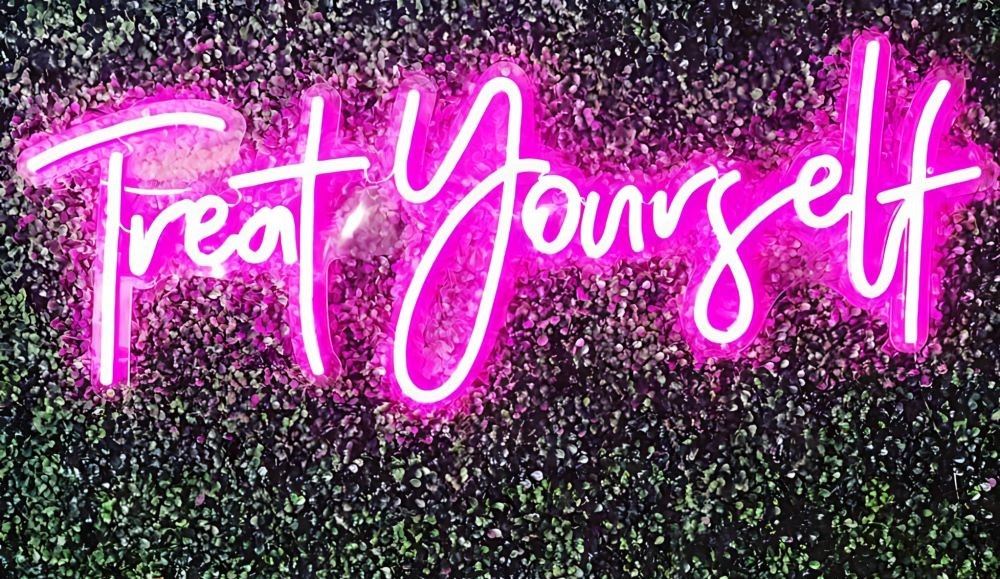 Treat Yourself by Custom Neon® - persuasive commercial salon signage on greenwall