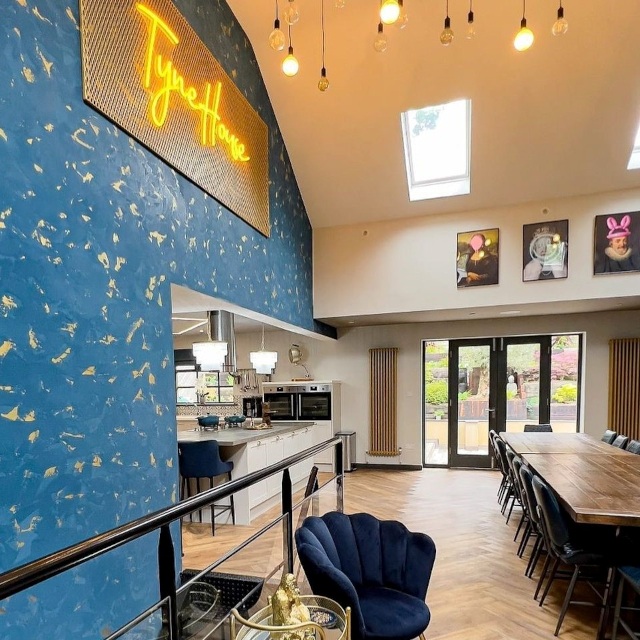 Tyne House yellow Custom Neon® airbnb on a blue wall overlooking the open plan kitchen dining room @tynehouse in Newcastle UK
