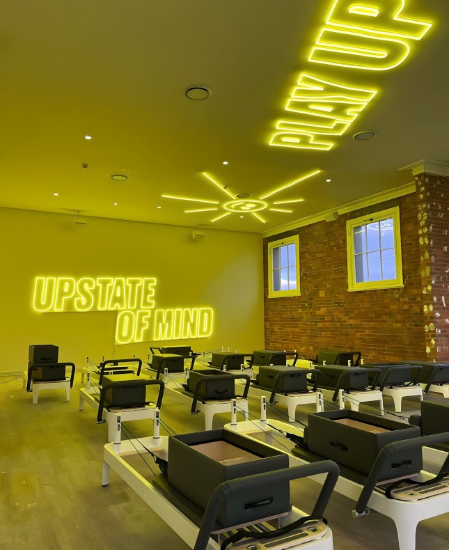 Large yellow Custom Neon® branded signs and artwork on the wall & ceiling @upstate_studios
