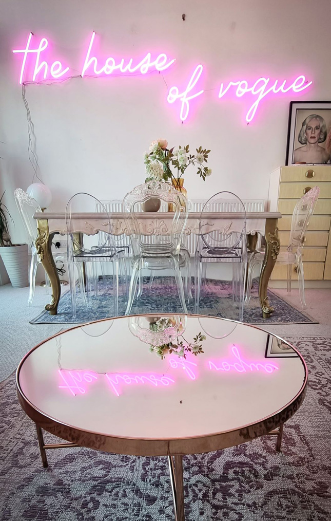 Pink Custom Neon® The House of Vogue sign in airbnb listing