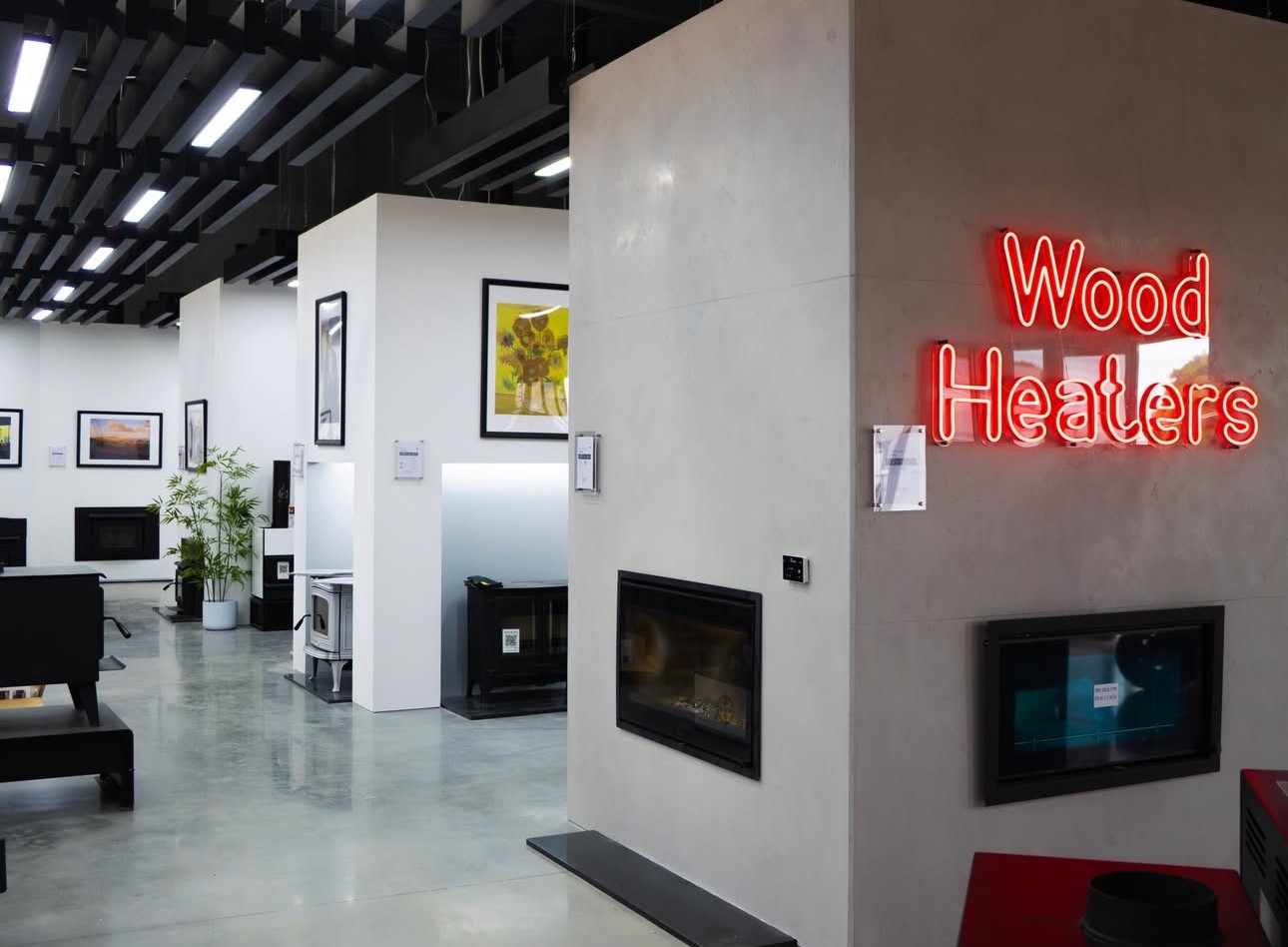Wood Heaters red LED neon double lined directional sign made by Custom Neon® mounted on a white wall in the Pivot Stoves showroom
